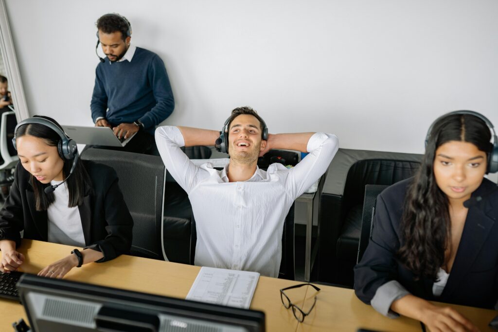 Call center professionals at work stations, showcasing teamwork and communication.